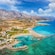 A rural coastline with mountains on a sunny day